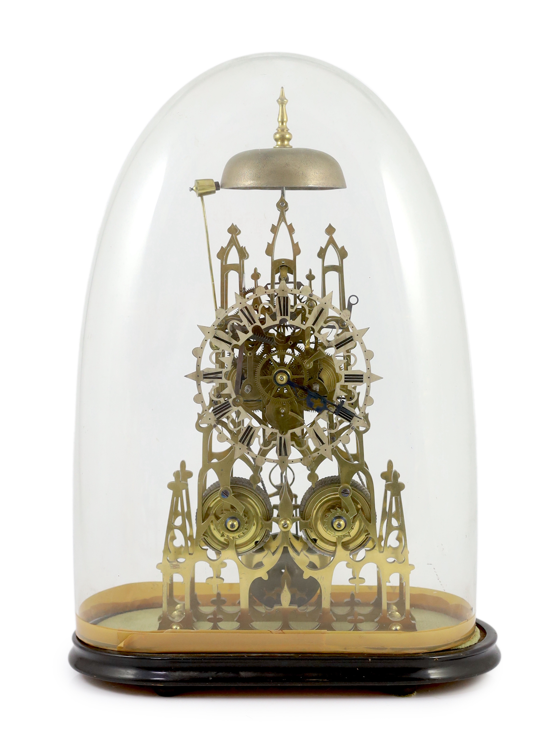 A Victorian brass cathedral skeleton clock, 46cm high, with ebonised stand and glass dome, overall 52cm high